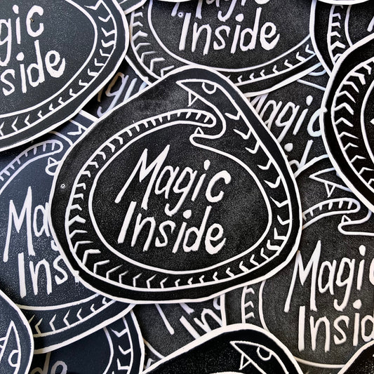 Stickers with 'Magic Inside' text on a black background