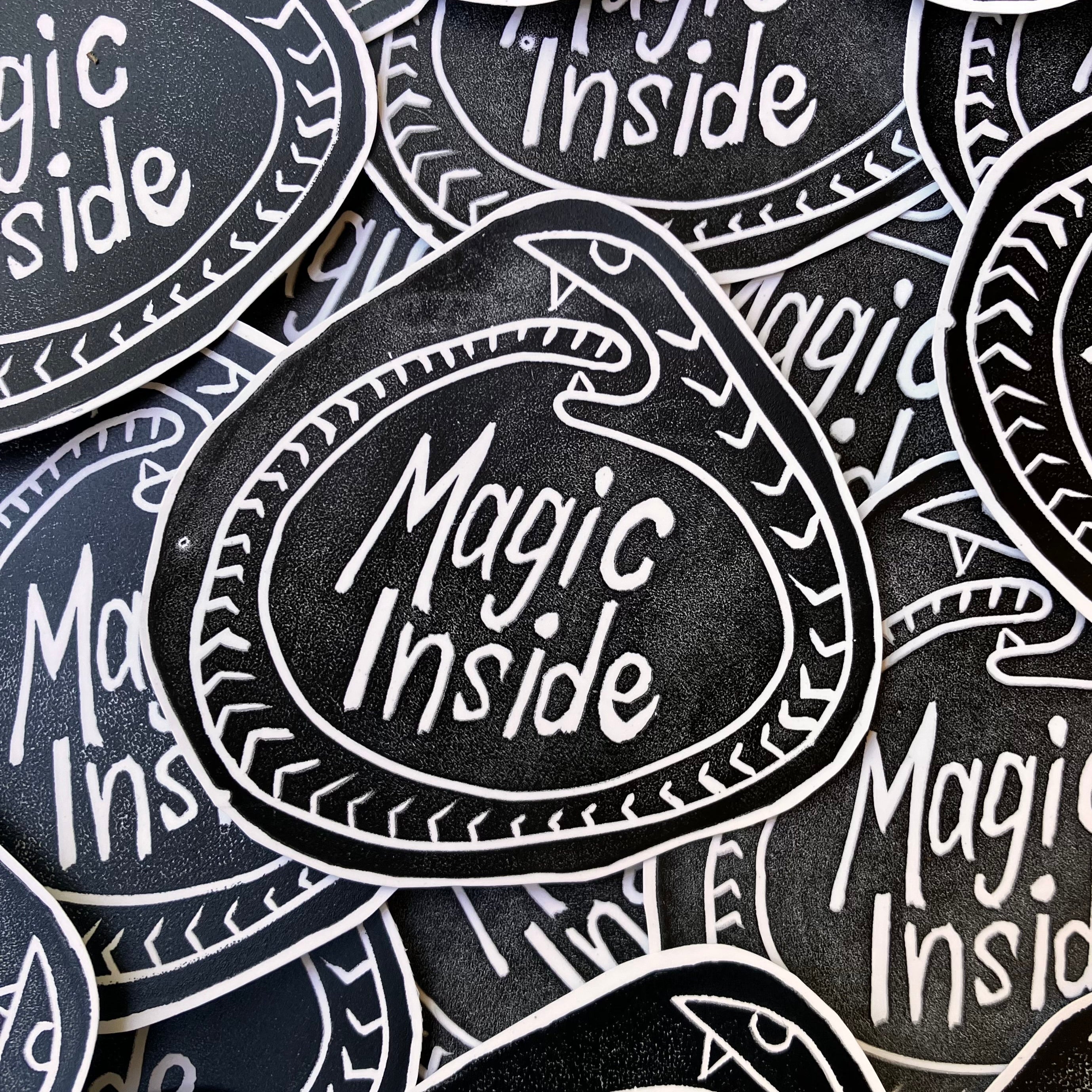 Stickers with 'Magic Inside' text on a black background