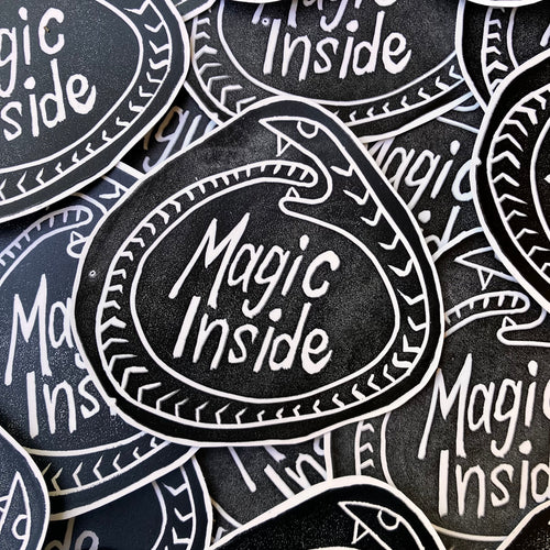 Stickers with 'Magic Inside' text on a black background