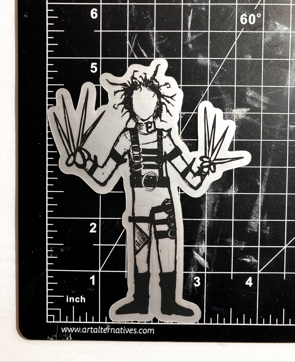 Black and white illustration of Edward Scissorhands on cutting mat